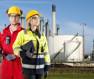 Two safety specialists monitoring the perimeter of a petrochemical refinary, using electroncial devices, such as cb radios and tablets